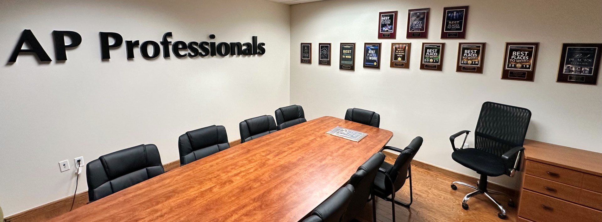 AP Professionals boardroom in Scottsdale, with Best Places to Work plaques on the wall
